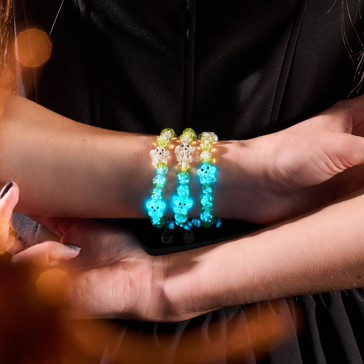 Garden Spectre glowing Firefly Glass ghost bracelets with silver finish on model's wrist by NOGU